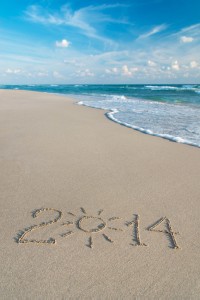 Happy New Year 2014 season concept on sea beach with the sun ray