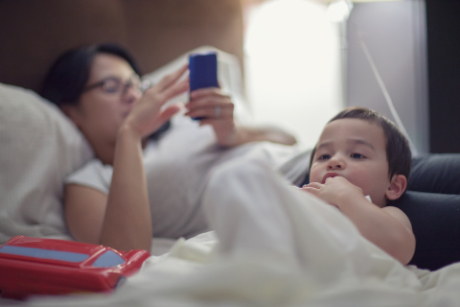 Boy laying in bed with mother